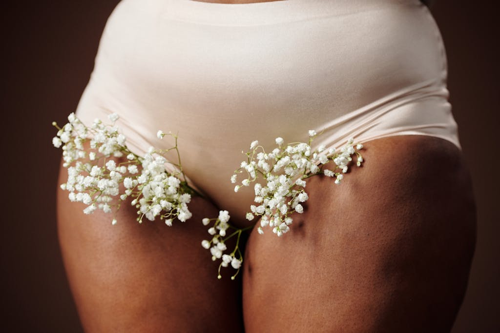 Close-up of a woman wearing white underwear adorned with baby's breath flowers, showcasing beauty and nature.