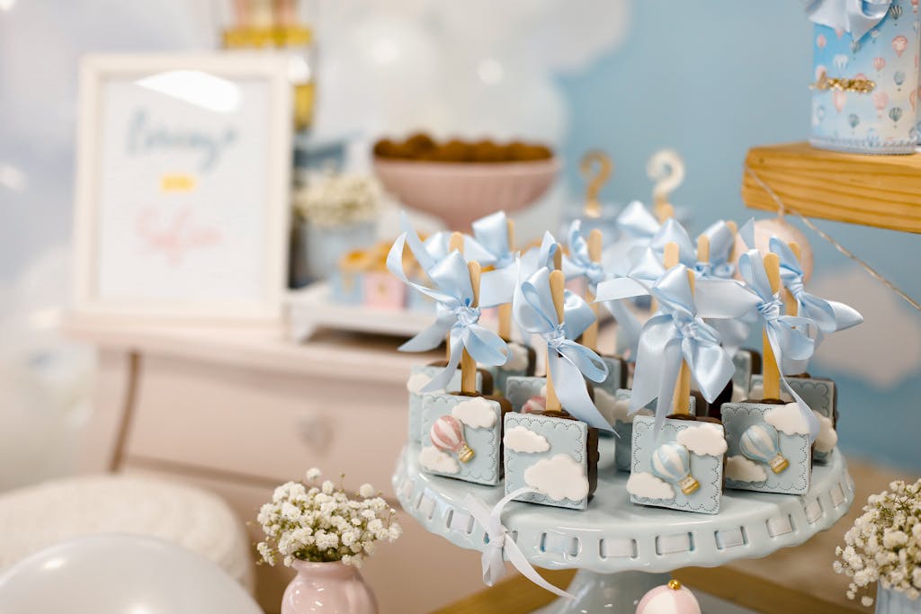 Elegant baby shower dessert table with pastel decorations and sweet treats.